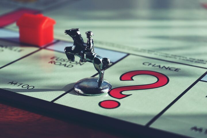 horse miniature toy on top of monopoly board game