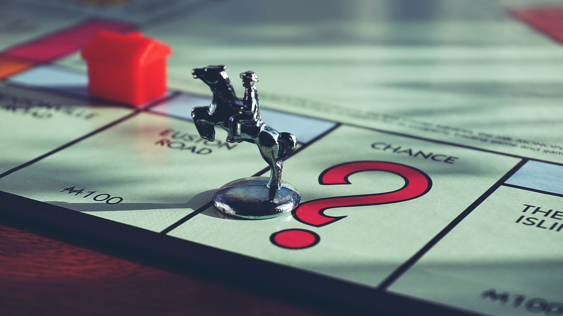 horse miniature toy on top of monopoly board game