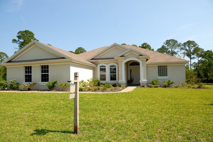 white and brown concrete bungalow under clear blue sky