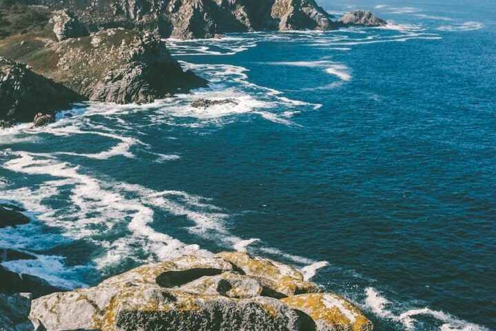 water waves splashing rocks on shore