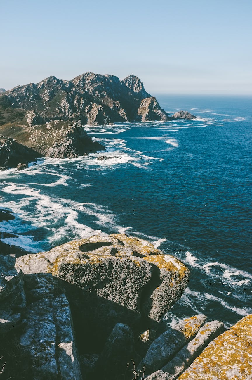 water waves splashing rocks on shore