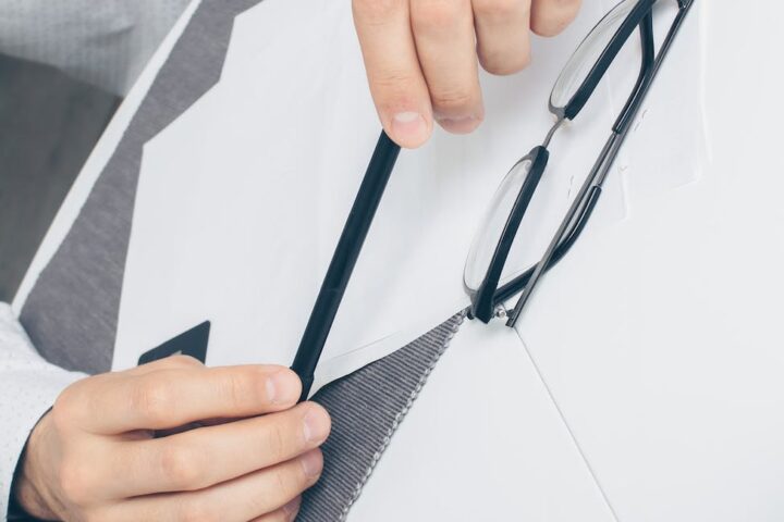 person holding black framed eyeglasses