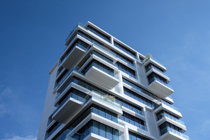 white concrete building under sunny blue sky