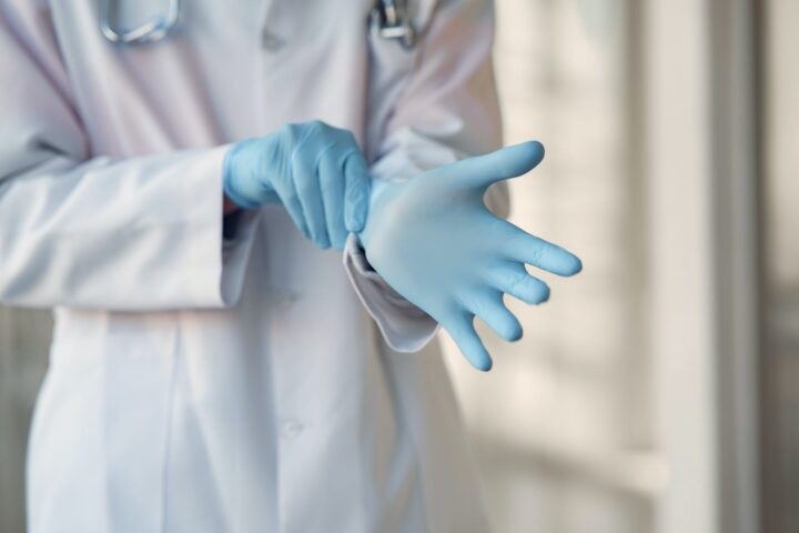 person wearing blue sterile gloves