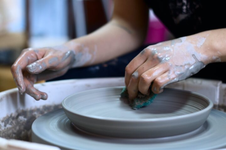 person making clay pot