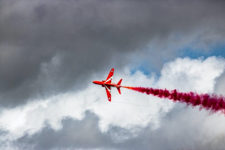 airplane with smoke flying in the sky