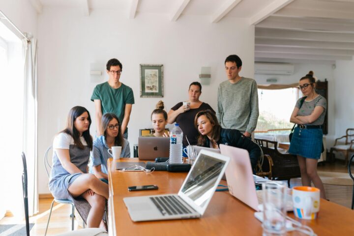 group of people watching on laptop