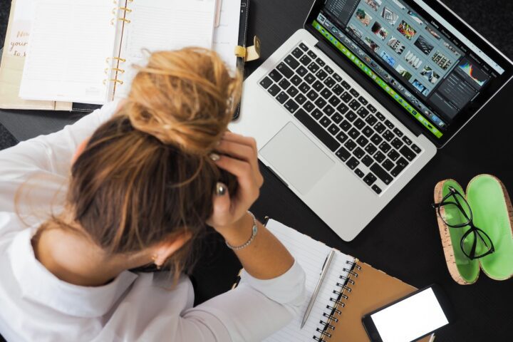 woman sitting in front of macbook