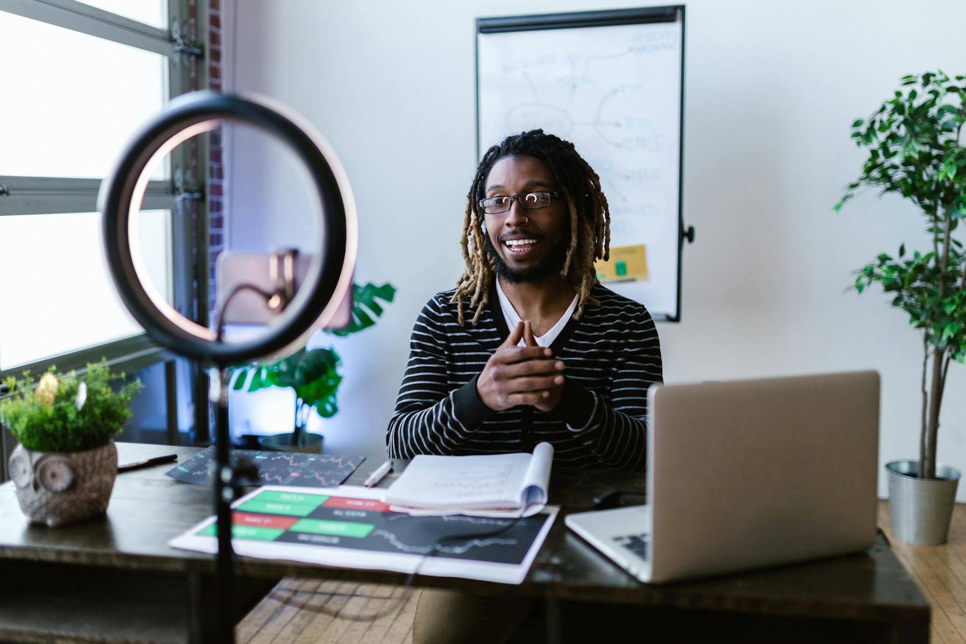 man with dreadlocks streaming for a finance blog