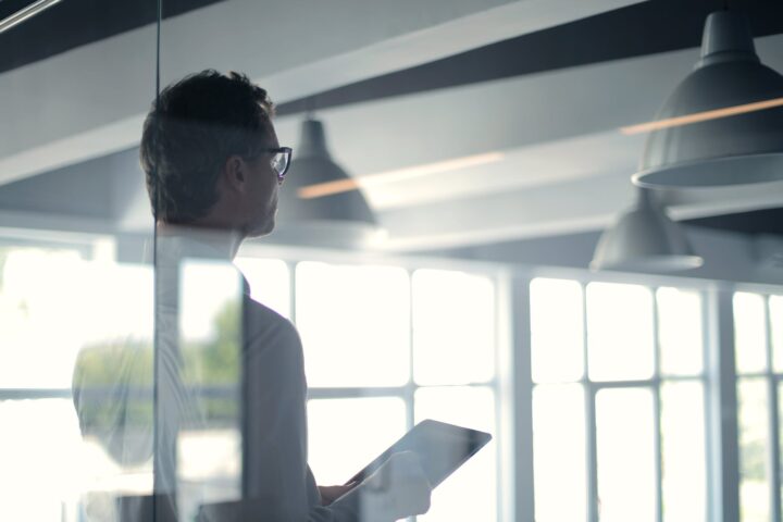 formal man with tablet giving presentation in office