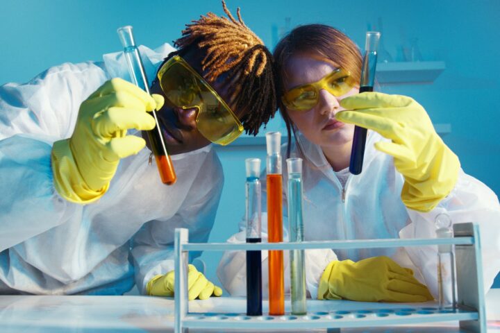 a man and a woman holding a test tube