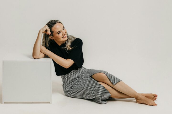 studio shot of a young woman in a fashionable outfit