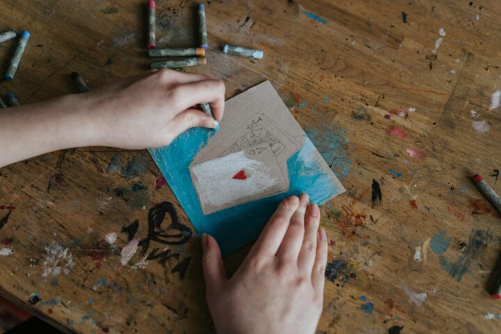 a person coloring cards drawing in a cardboard