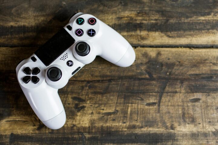 white gaming console on wooden surface